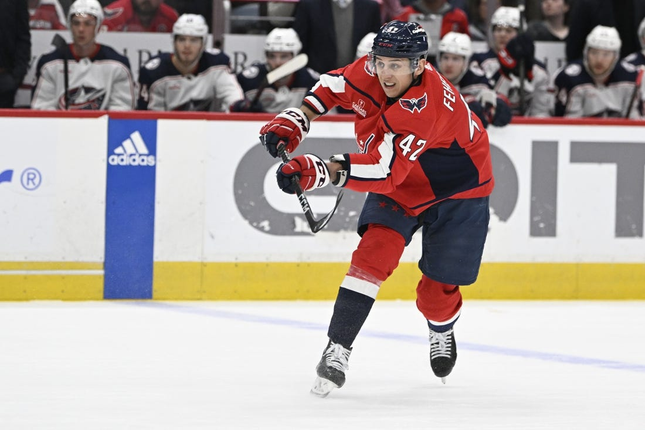 Mar 21, 2023; Washington, DC, USA; Washington Capitals guard Martin Fehervary (42) assists Washington during the first quarter of their game against the Columbus Bluejackets at Capital One Arena Goal by Capitals right wing TJ Oshie (not shown).